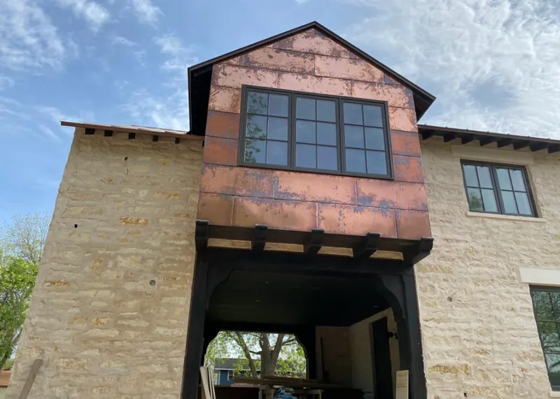 Copper metal panel facade on a stone building for Skylight Installation in Gilroy